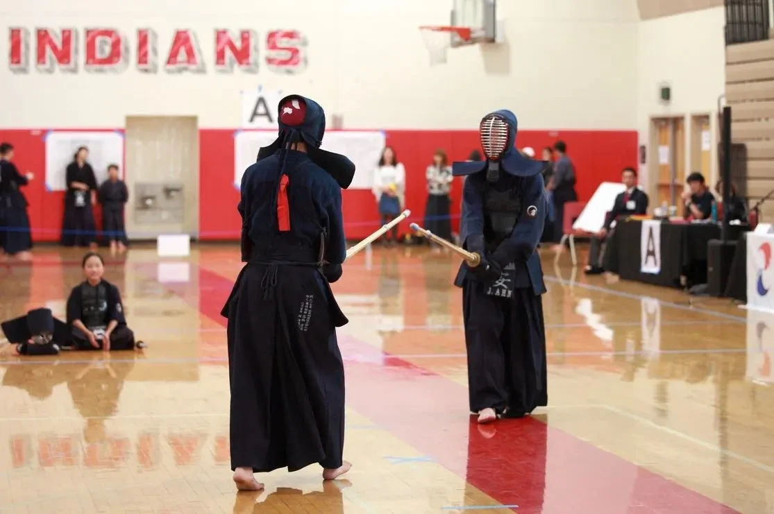 Two LCKA Kendo practitioners facing each other during a tournament match.