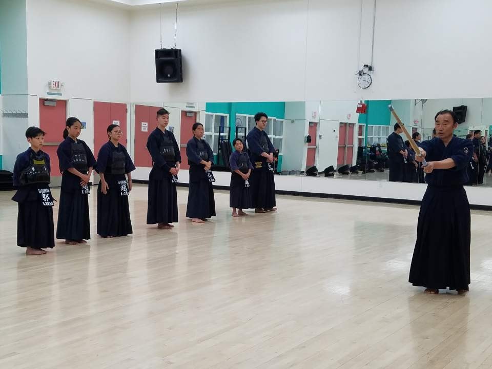 LCKA instructor demonstrating Kendo technique to students during practice.